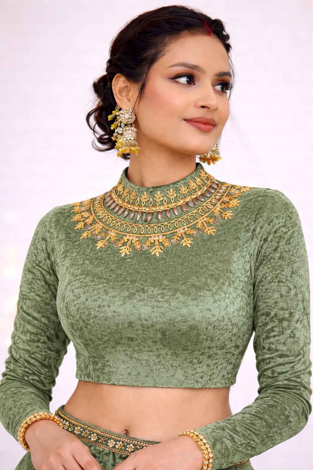 Description Ye sage green velvet blouse premium quality velvet fabric se bana hai jo soft feel aur royal finish deta hai. Front side par intricate golden embroidery work kiya gaya hai jisme beads, stone aur floral motifs use hue hain, jo blouse ko elegant aur rich look dete hain. High-neck design classy aur modern feel deta hai, jo wedding, festive aur party wear ke liye perfect hai. Velvet ka natural texture close-up me clearly visible hai, jo product ki premium cloth quality ko highlight karta hai. Back side me stylish deep cut with dori & latkan diya gaya hai, jo traditional aur trendy design ka perfect combination hai. Ye blouse silk, georgette, net aur heavy sarees ke saath beautifully match karta hai. ✨ Key Features: Fabric: Premium Velvet Color: Sage Green (Unique Shade) Work: Heavy Golden Embroidery Neck: High Neck Back: Deep Back with Dori & Latkan Sleeves: Full Sleeves Occasion: Wedding | Party | Festive Wear 🚚 Cash on Delivery Available 🔄 Easy Return Option