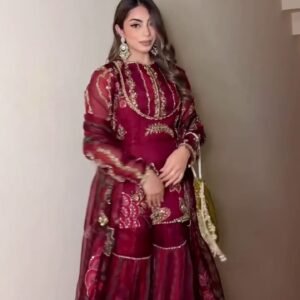 This breathtaking ensemble features a deep maroon kurti beautifully embellished with intricate golden embroidery ✨🌺. The embroidery includes floral motifs, structured patterns, and shimmering threadwork that adds richness to the entire look. The kurti is designed with full sleeves made from lightweight sheer fabric, decorated with matching motifs that create a royal and festive charm 👑💫.Maroon Apparel Collection The sharara bottom flows gracefully with wide flares, enhancing every step with elegance and movement 💃💕. The layered design adds volume while still maintaining comfort, ensuring you look stylish without compromising ease. The sharara is adorned with embroidered borders and delicate lines that beautifully complement the kurti 🌟🌿.